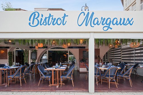 Bistrot Margaux - Local Favorite Bistro in Antibes Interior of Bistrot Margaux in Antibes with Provençal decor and wooden tables