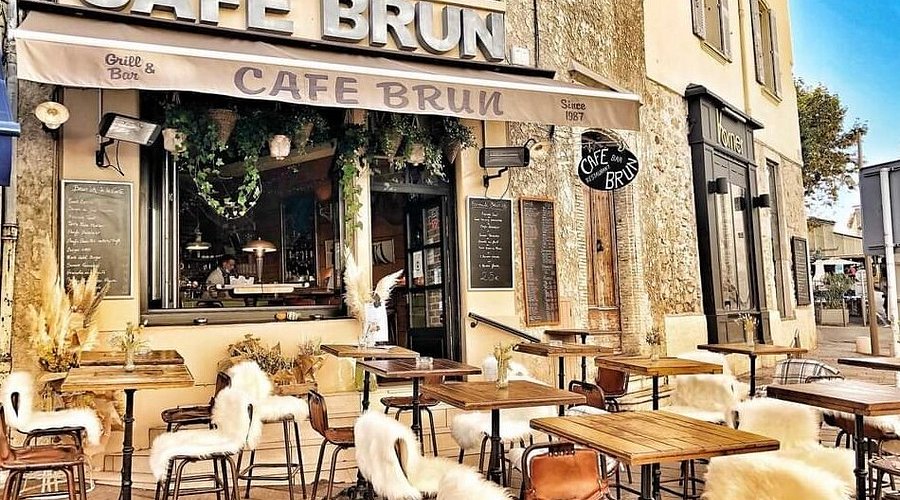 Café Brun - Funky Local Eatery in Antibes Café Brun exterior with fur-covered chairs and bohemian cafe vibe in Antibes