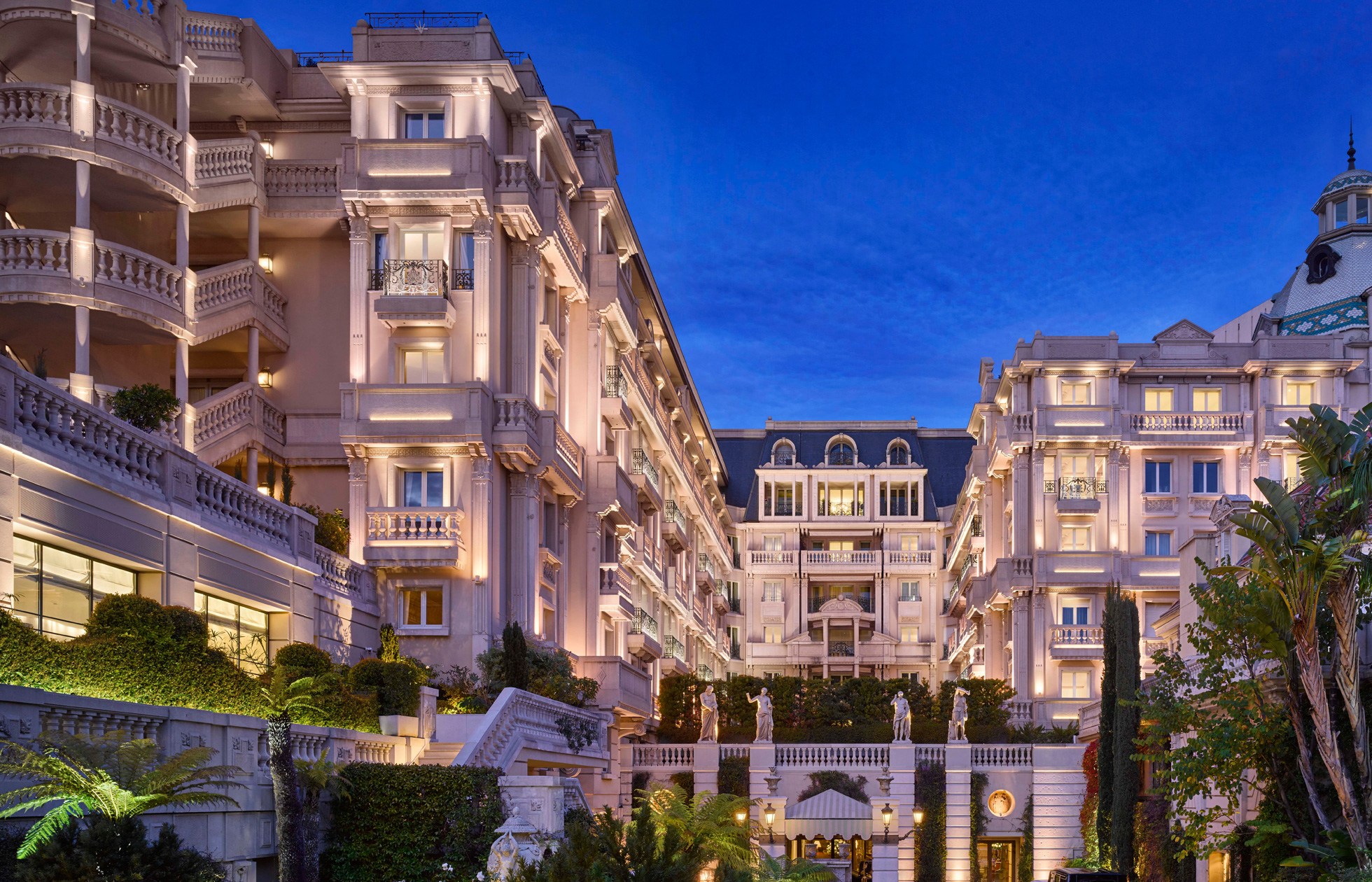 Elegant architecture of Hotel Metropole Monte-Carlo lit at twilight