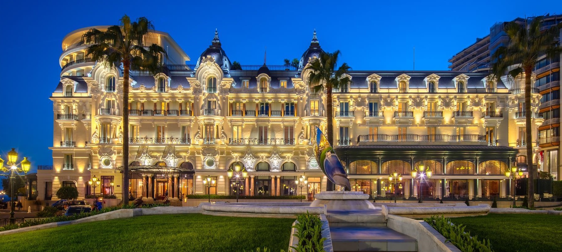 Best 10 Hotels in Monaco – Luxury, Romantic & Budget Gems, Exterior view of Hôtel de Paris Monte-Carlo lit up at night in Monaco