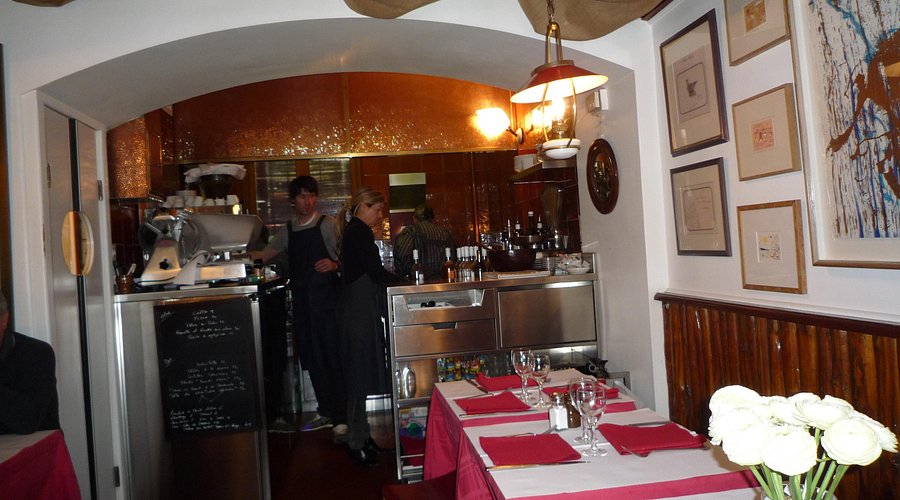 Authentic Niçoise cuisine at La Merenda – Local gem in the heart of Nice Rustic interior of La Merenda with red tablecloths and chalkboard menu