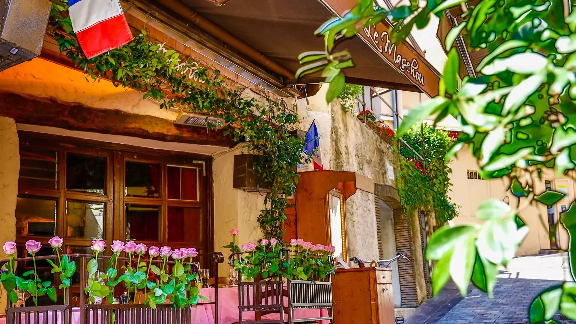 Le Maschou – romantic steakhouse tucked in Cannes’ old town Le Maschou restaurant with rustic decor and pink roses in Cannes