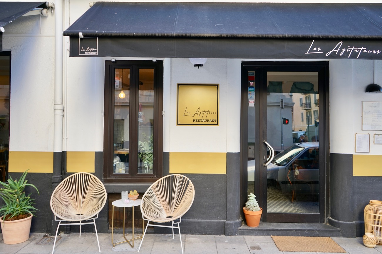 Inventive French tasting menus and natural wines at Les Agitateurs in Nice Modern facade of Les Agitateurs restaurant with black and yellow accents
