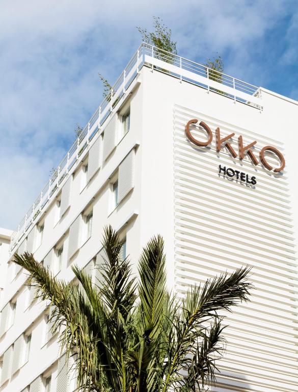 OKKO Hotels Cannes Centre – Chic and central stay Modern facade of OKKO Hotels Cannes Centre with palm tree