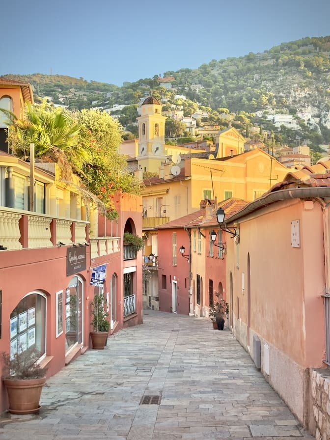 Old Town – Strolling the charming lanes of Villefranche-sur-Mer Top 5 Amazing Things to Do in Villefranche-sur-Mer, Narrow pastel-colored street in Villefranche-sur-Mer Old Town