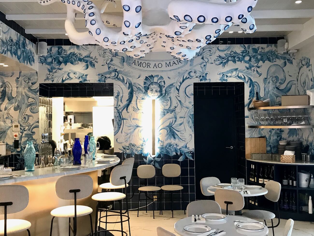 Fresh ceviche and seafood with Peruvian twist at Peixes – Modern dining in Nice Stylish seafood restaurant Peixes with blue and white tiled decor and octopus sculpture