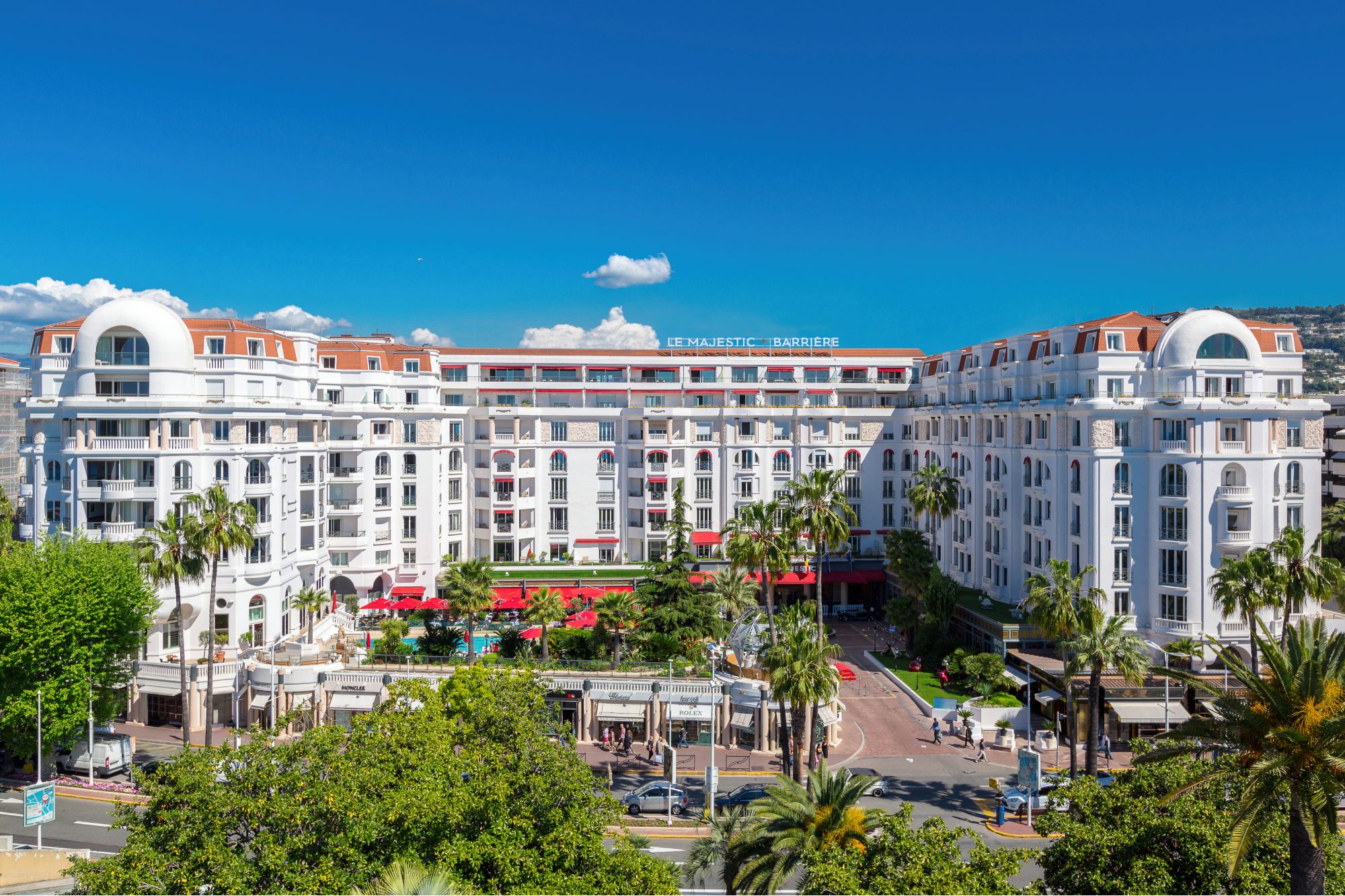 Luxury stay at Hôtel Barrière Le Majestic Cannes Best 10 Hotels in Cannes – Luxury, Romantic & Budget Gems, Majestic white facade of Hôtel Barrière Le Majestic with palm trees