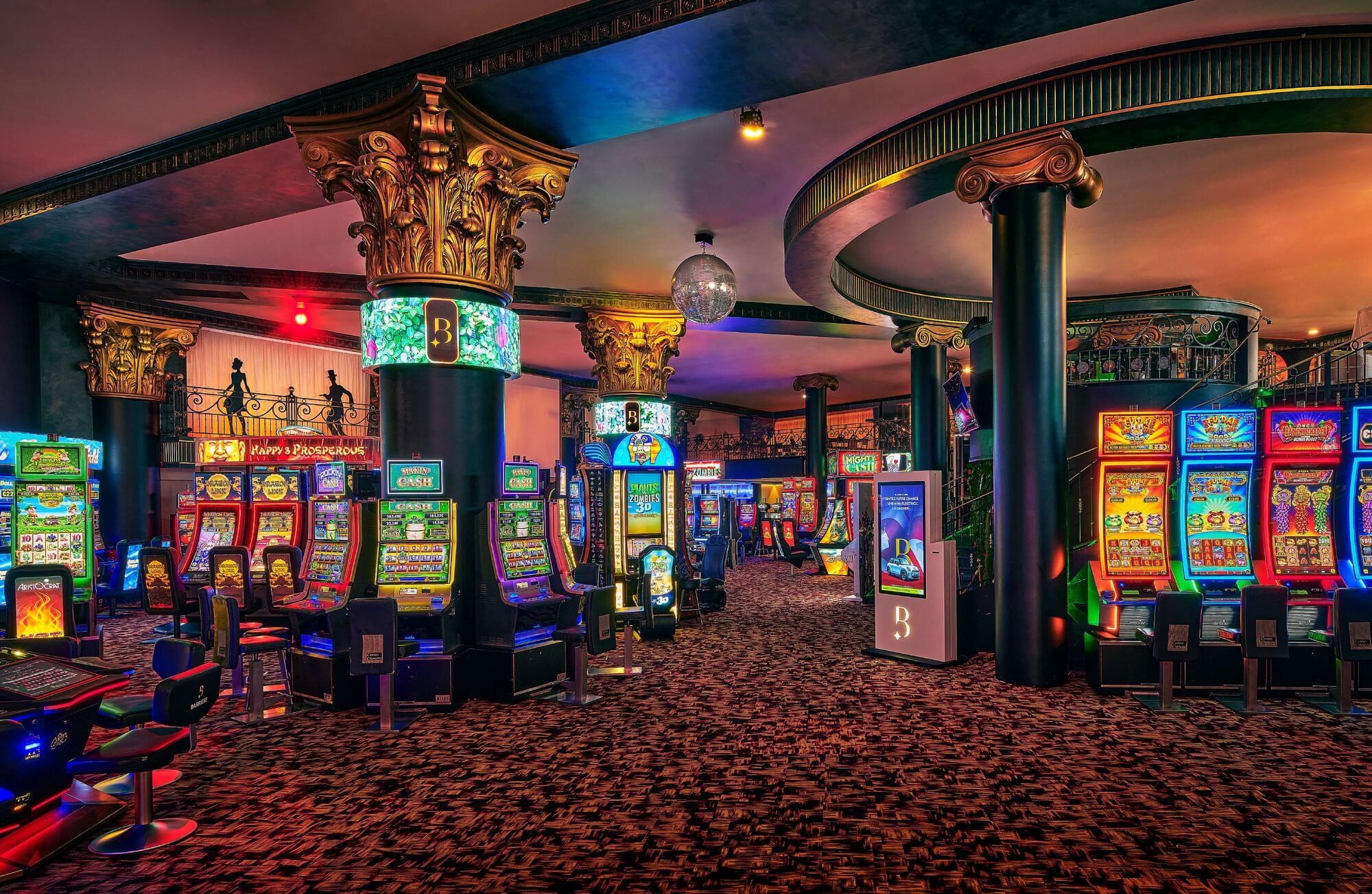 Try your luck in style at Casino Barrière Cannes Elegant interior of Casino Barrière with bright slot machines and bar