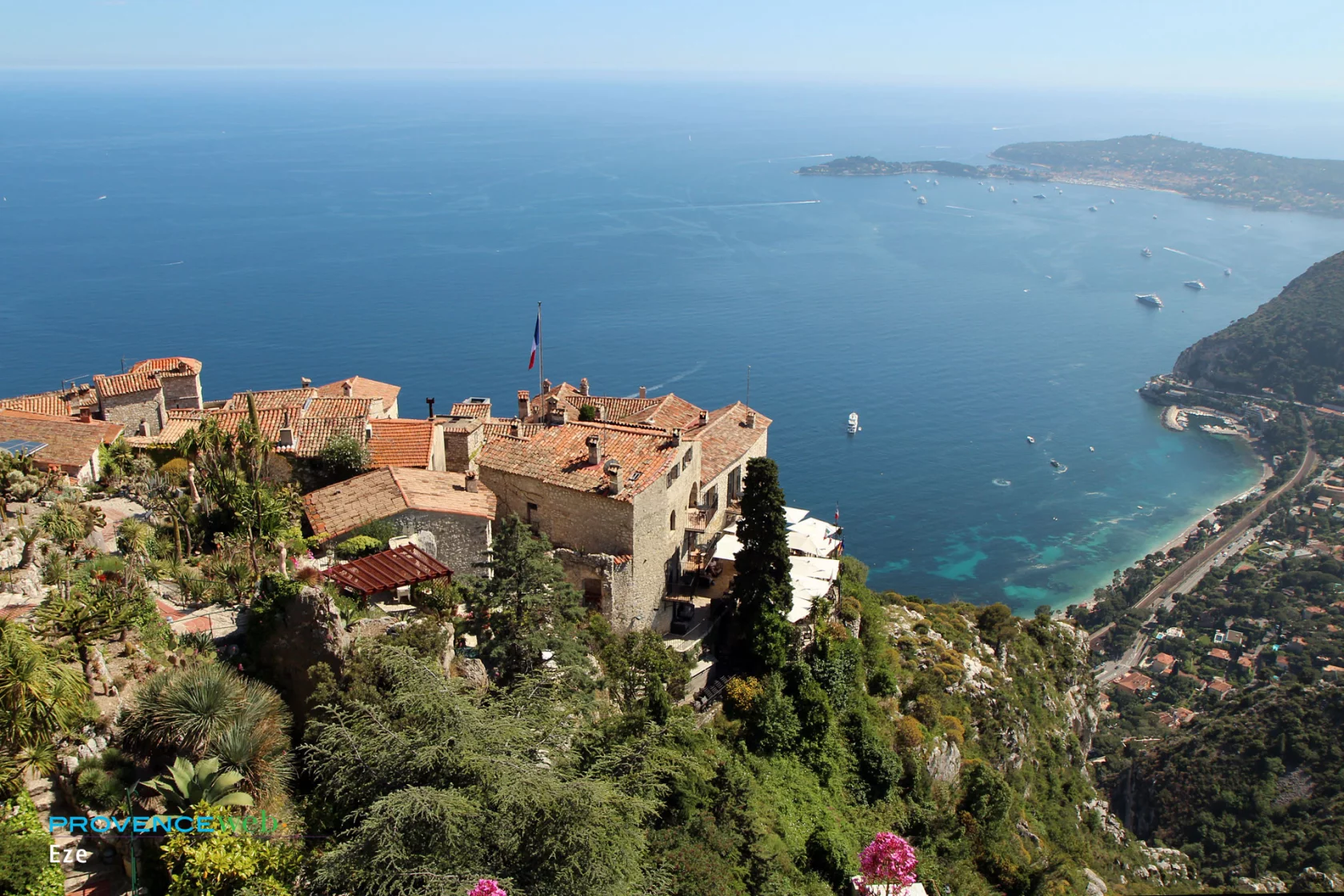 Èze Villad - A panoramic view of Eze A panoramic view of Eze, France, showcasing the town's colorful buildings and the Mediterranean Sea from a hilltop.