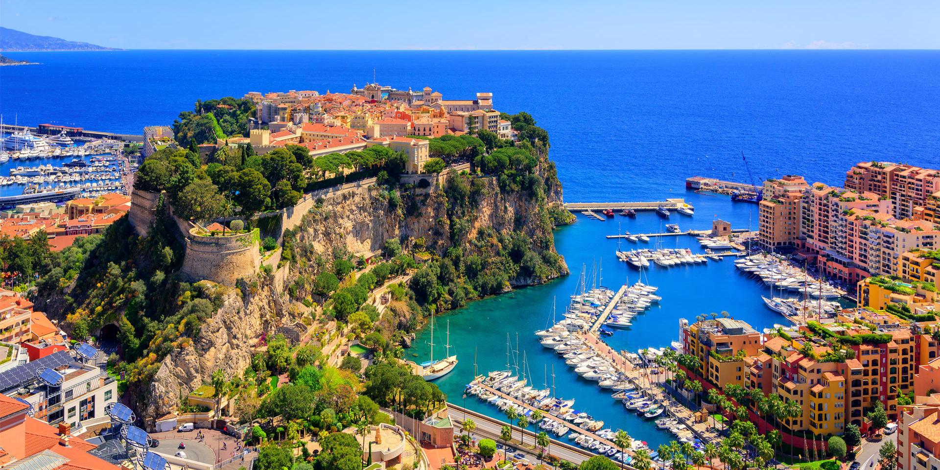 Aerial view of Monaco showing the royal palace, marina, and cliffside architecture