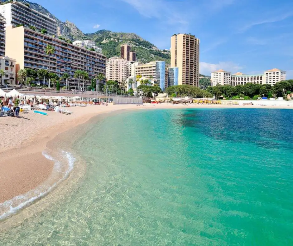 Relax on Larvotto Beach – Monaco’s Most Popular Seaside Spot Larvotto Beach in Monaco with calm blue waters and sunbathers