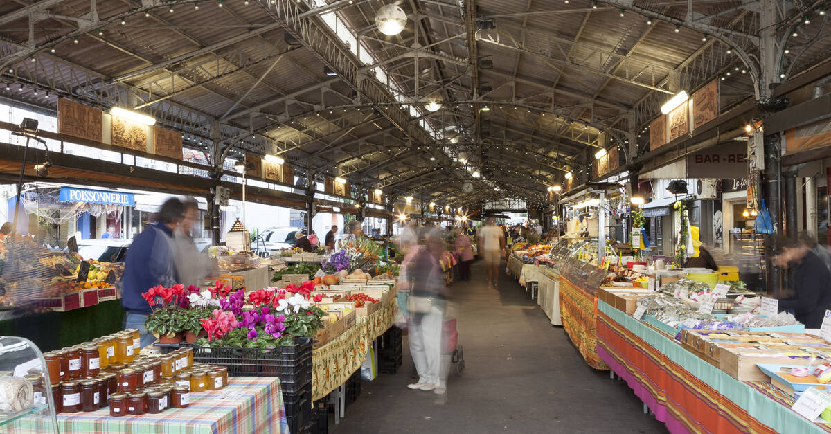 Discover Provençal Flavors at Marché Provençal in Antibes Local vendors selling cheeses, olives, and produce at Antibes’ market
