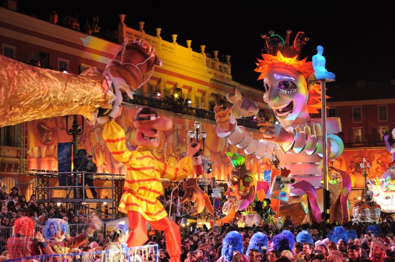 Magical night parade during the Nice Carnival Festival Colorful illuminated carnival floats and performers at night in Nice