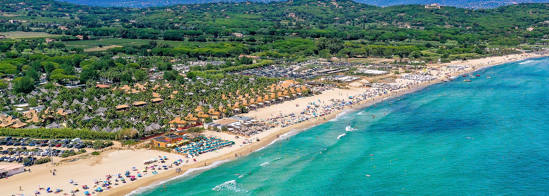 Pampelonne Beach – The Most Famous Stretch of Sand in Saint-Tropez Aerial view of Pampelonne Beach filled with beach clubs and sunbathers
