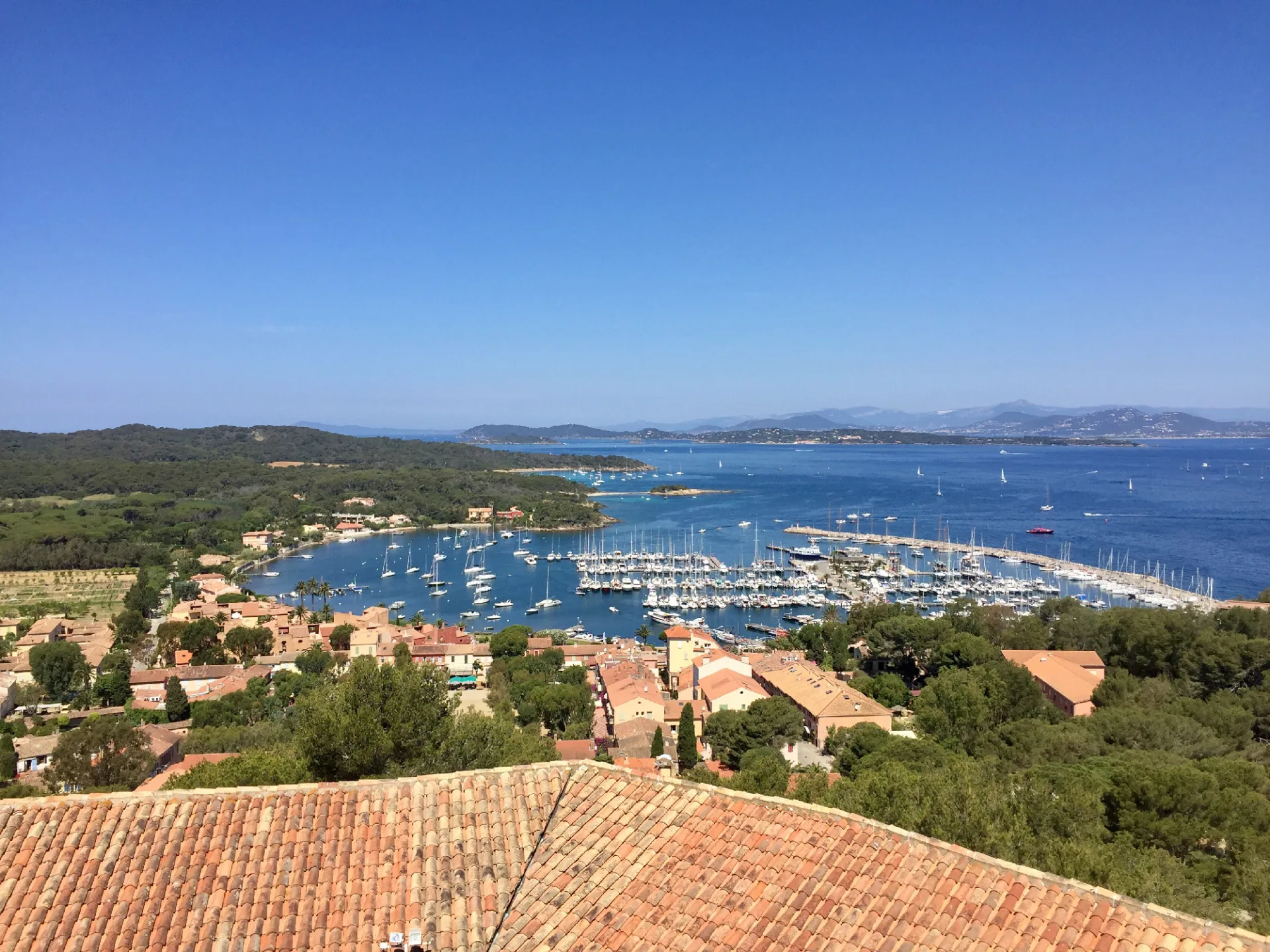 Escape to Porquerolles Island’s natural beauty Aerial view of Porquerolles Island with turquoise waters and greenery