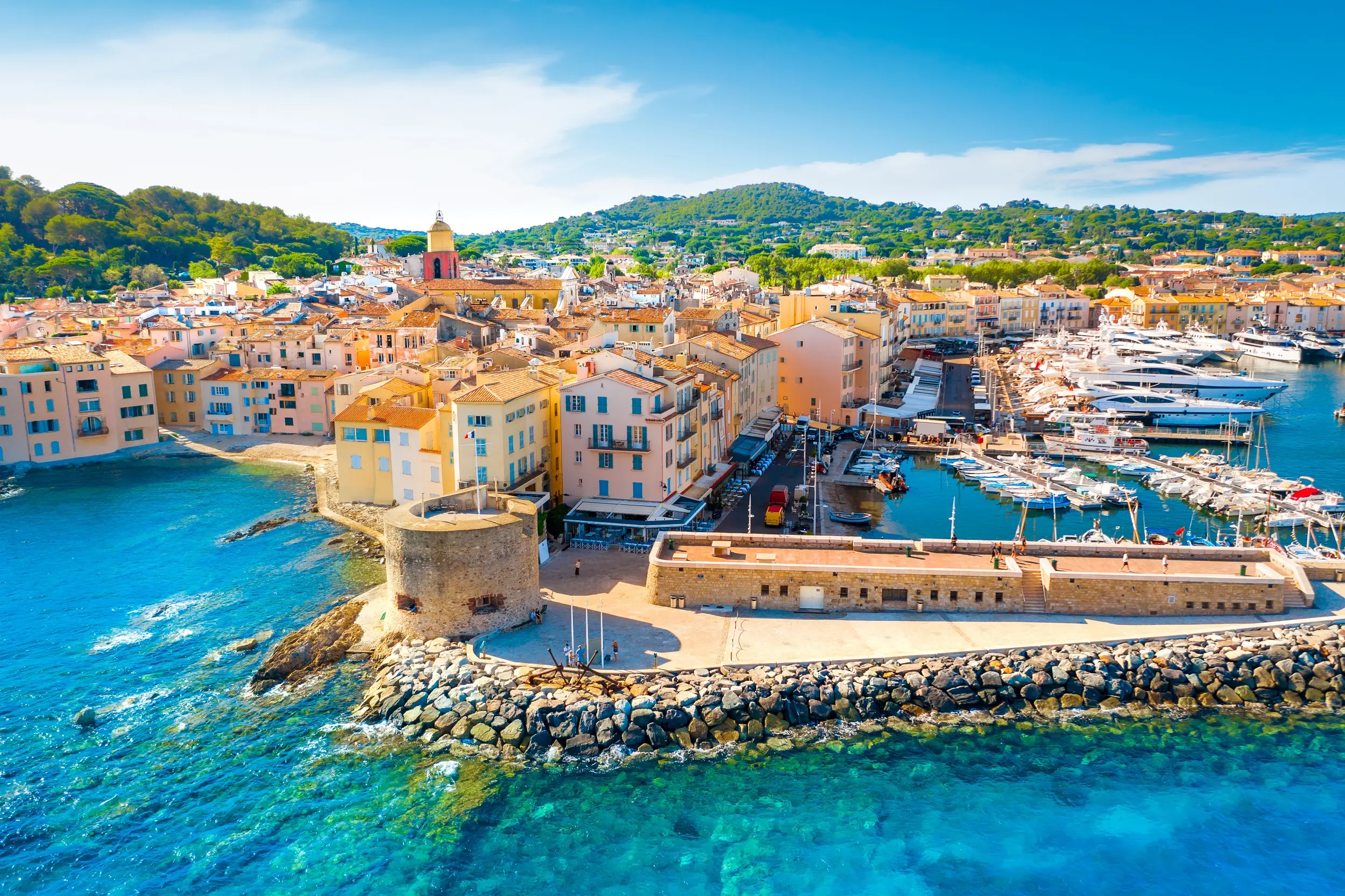 Luxury getaway in Saint-Tropez Colorful buildings and yachts in the port of Saint-Tropez on the French Riviera