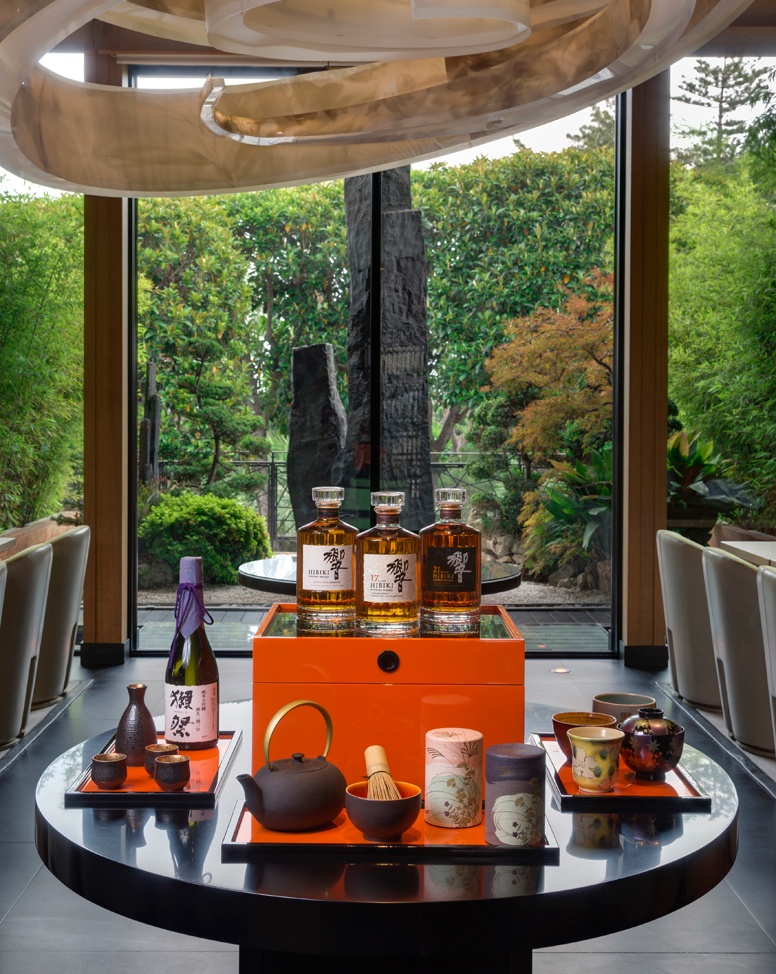 Yoshi Monaco – Michelin-Starred Japanese Cuisine in a Serene Garden Setting Japanese whisky and tea display inside Yoshi restaurant at Hôtel Metropole