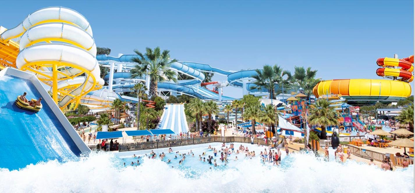 Enjoy the attractions and the wave pool at Aquasplash Antibes Panoramic view of Aquasplash Antibes with large wave pool, multiple slides and water play areas