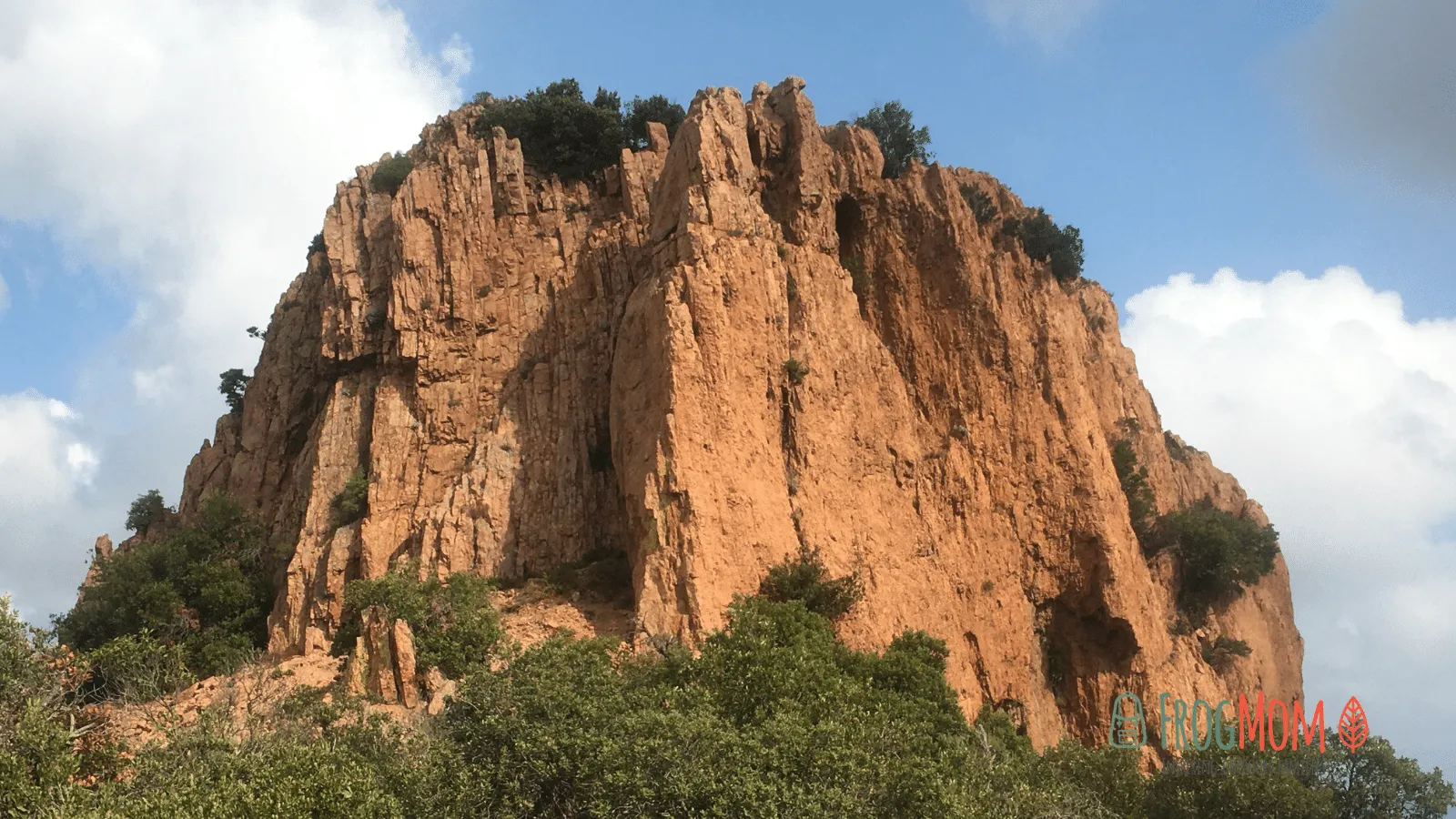 Red-rock coastal cliffs of the Estérel glowing above a calm Mediterranean in late afternoon