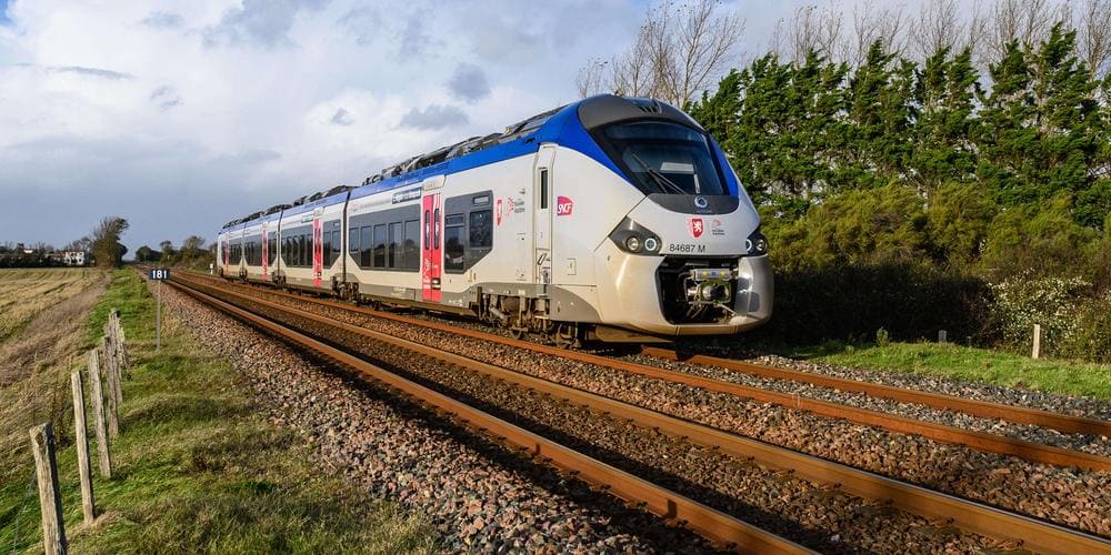 Regional train hugging the coastline with dazzling sea views between Nice and Monaco